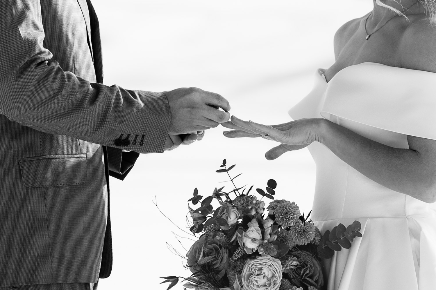 Getting legally married in Italy. Husband putting a ring on wife's finger.