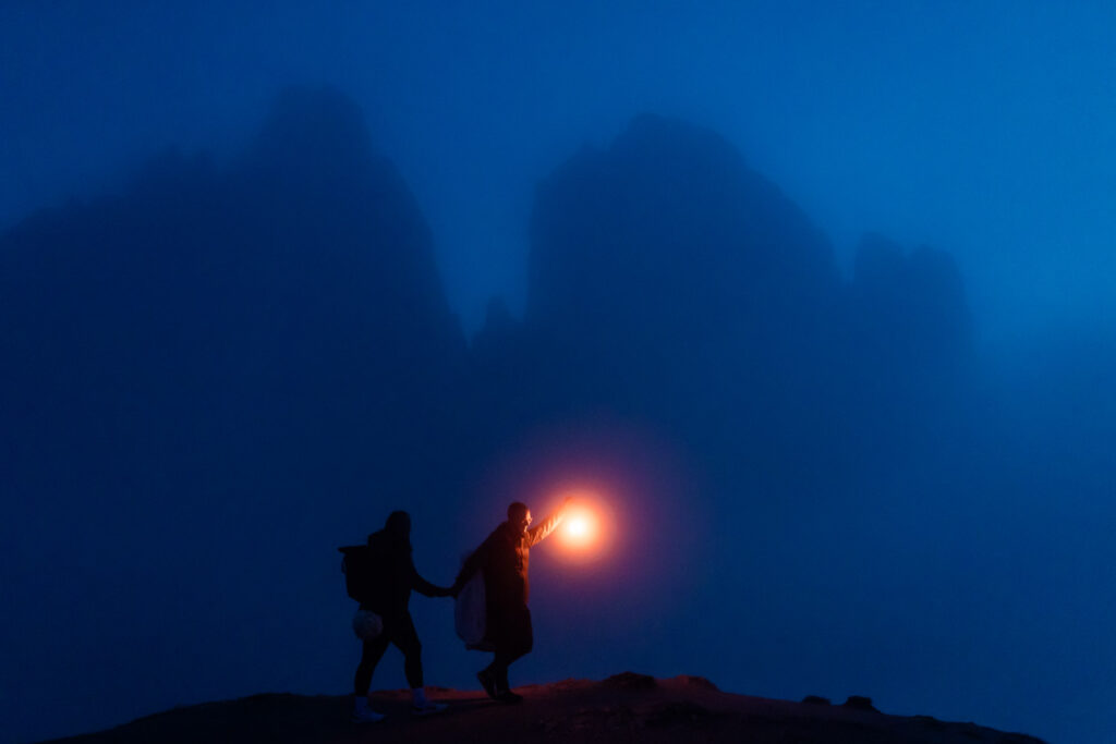 adventurous elopement couple with lanterns during night time at tre cime di lavaredo