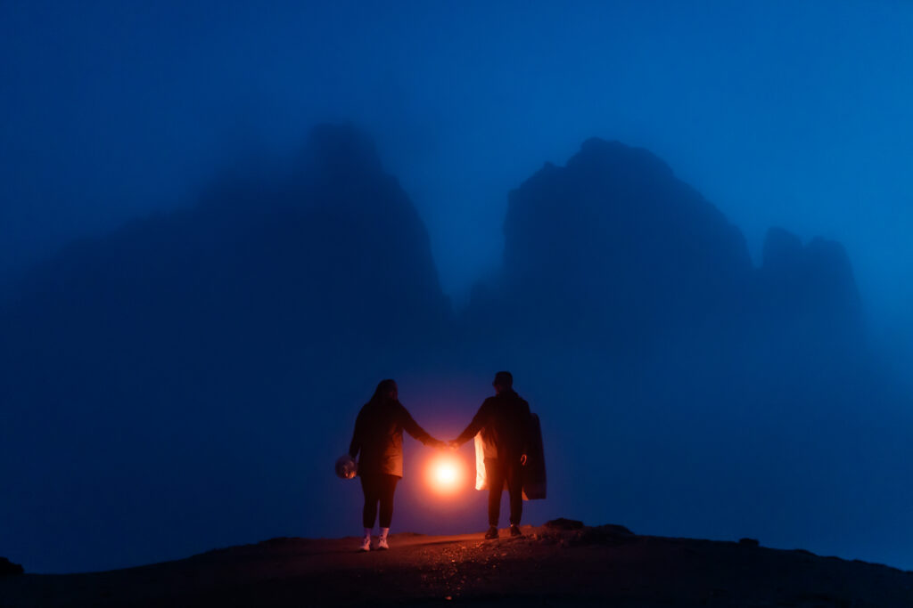 adventurous elopement couple with lanterns during night time at tre cime di lavaredo
