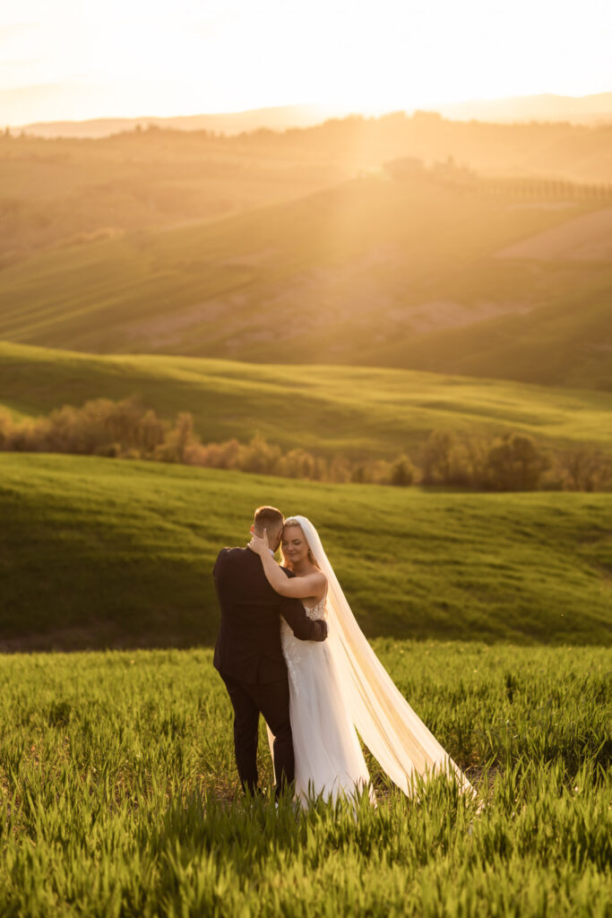 romantic bride and groom in a lush meadow in tuscany
