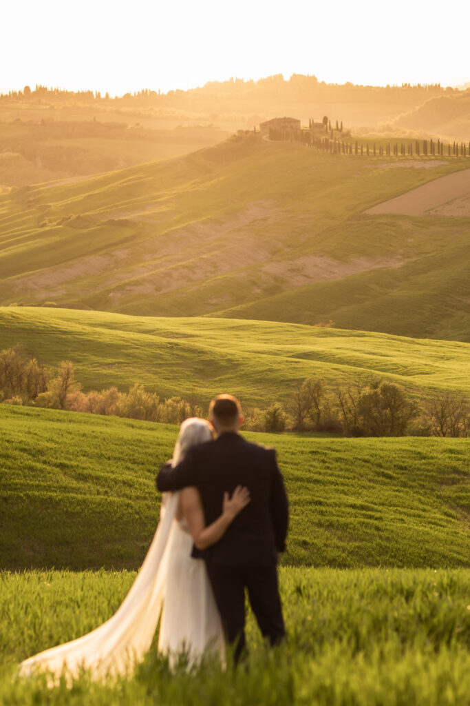 romantic bride and groom in a lush meadow in tuscany