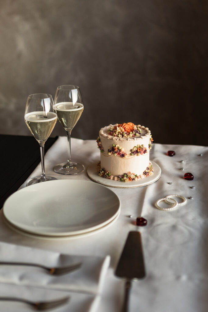 wedding cake set up with champagne glasses