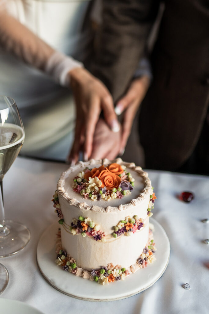 bride and groom cutting a cake during their Dolomites elopement day