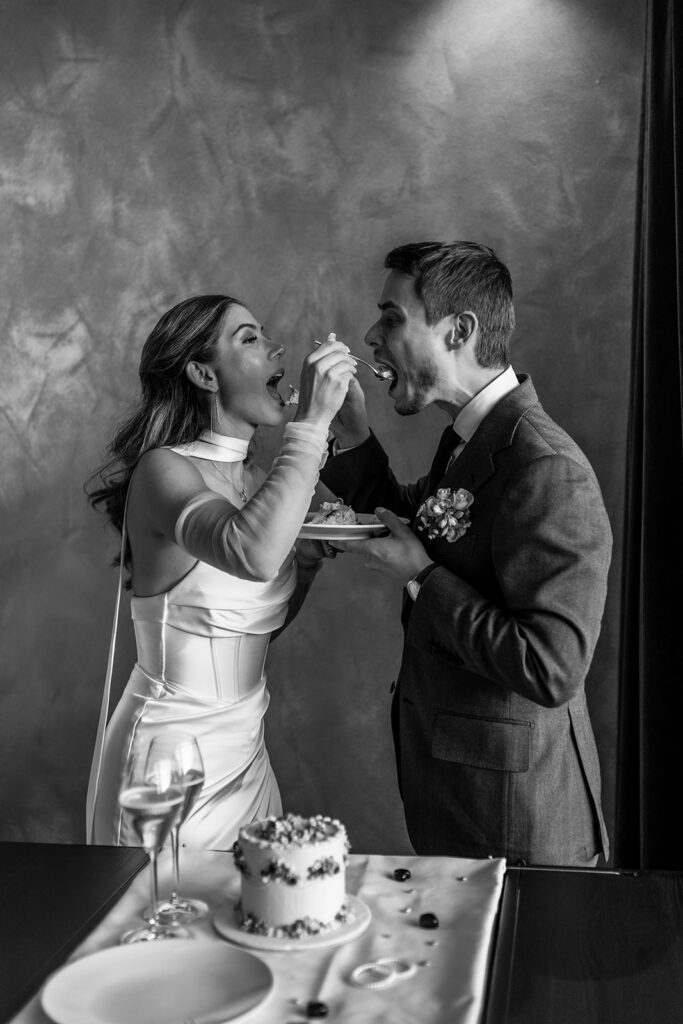 bride and groom cutting a cake during their Dolomites elopement day
