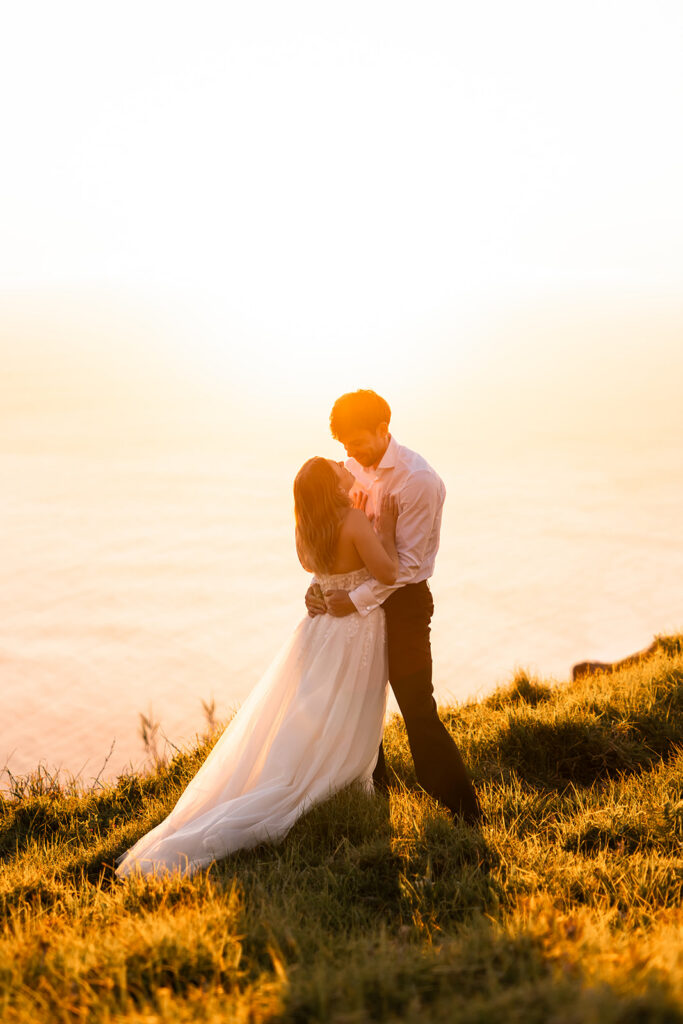 bride and groom holding each other for golden hour during madeira elopement