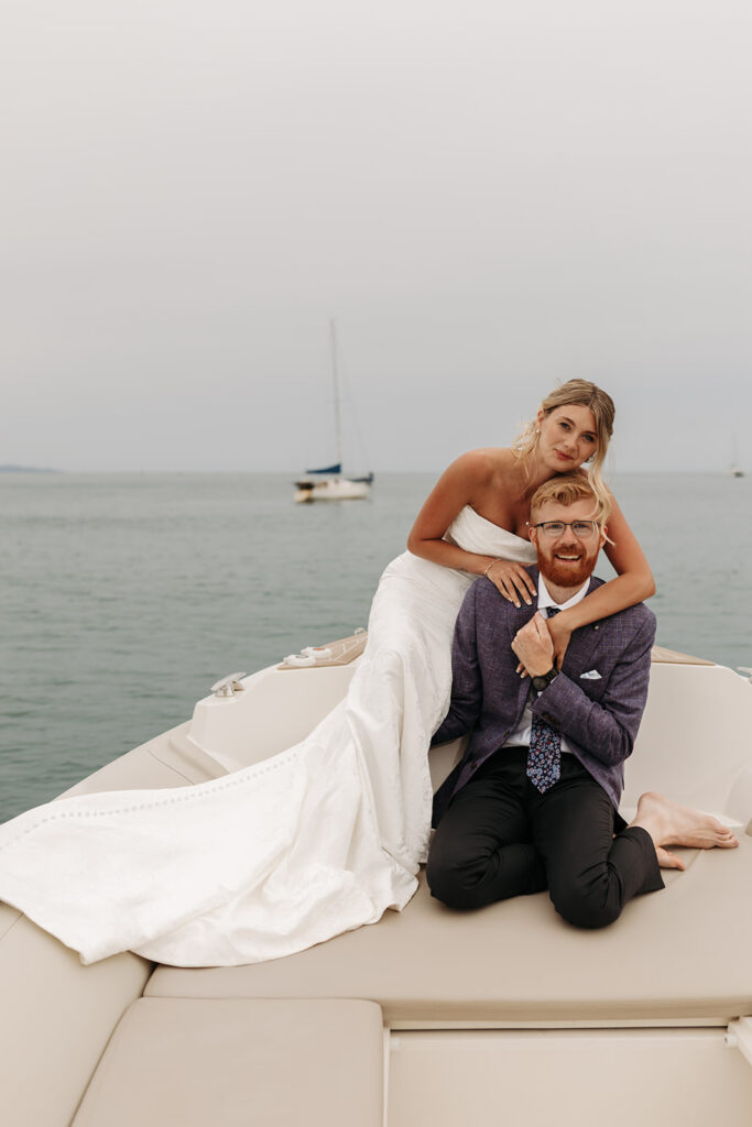 elopement couple posing on a boat during their sardinia elopement