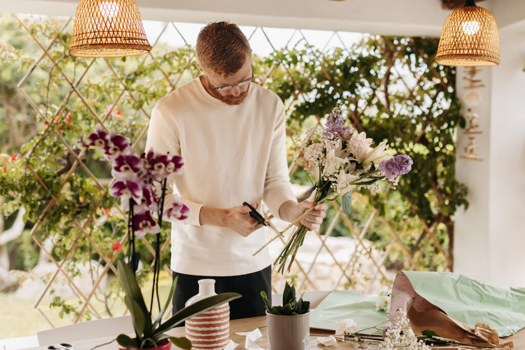 groom arranging a bouquet for his bride