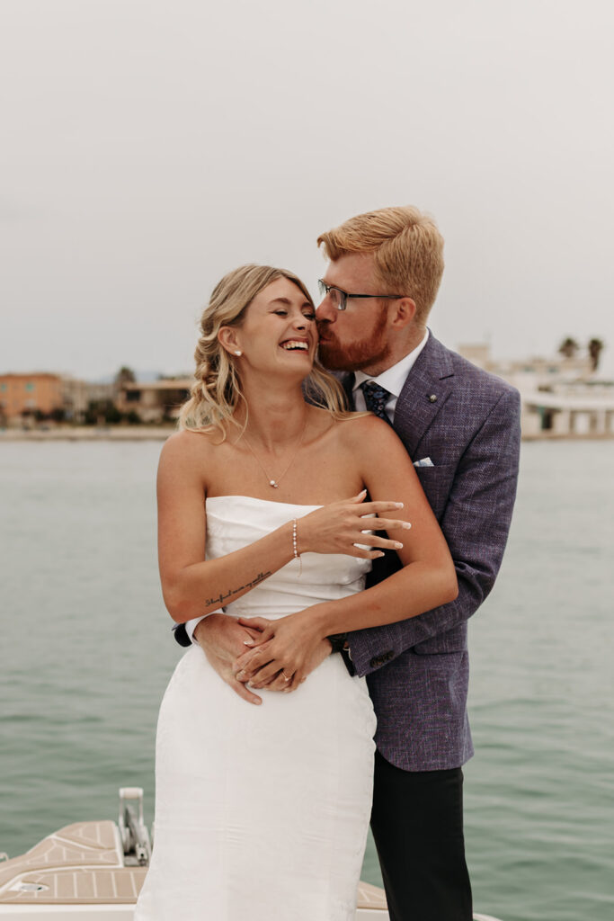 playful couple's moments on a boat during a sardinia elopement