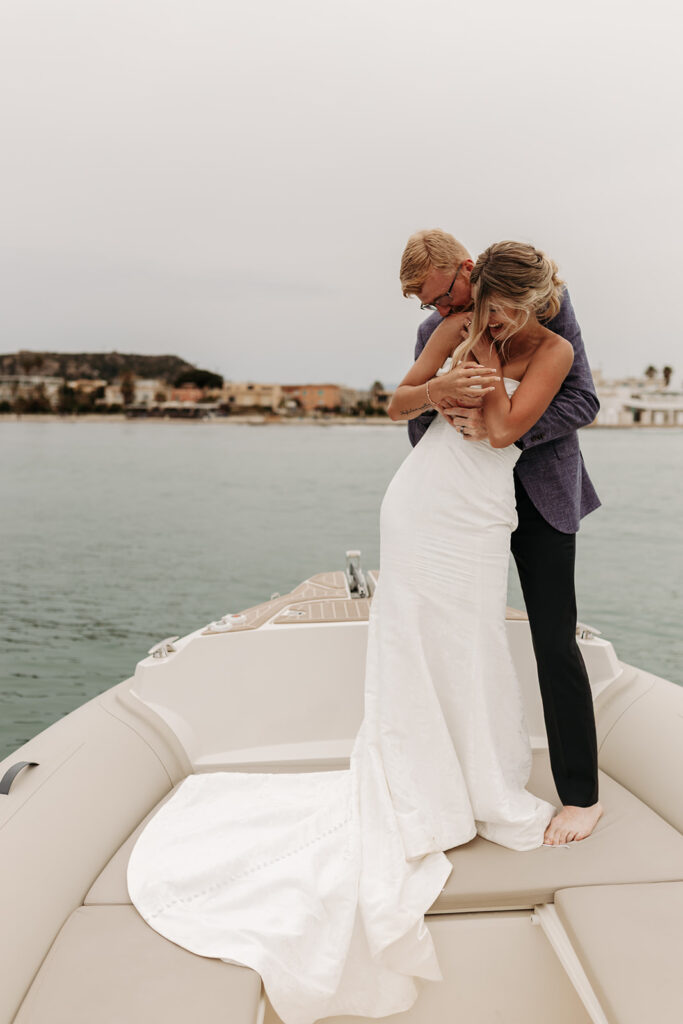 playful couple's moments on a boat during a sardinia elopement