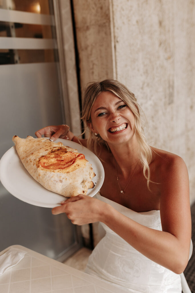bride and groom enjoying a pizza break in cagliari during their sardinia elopement