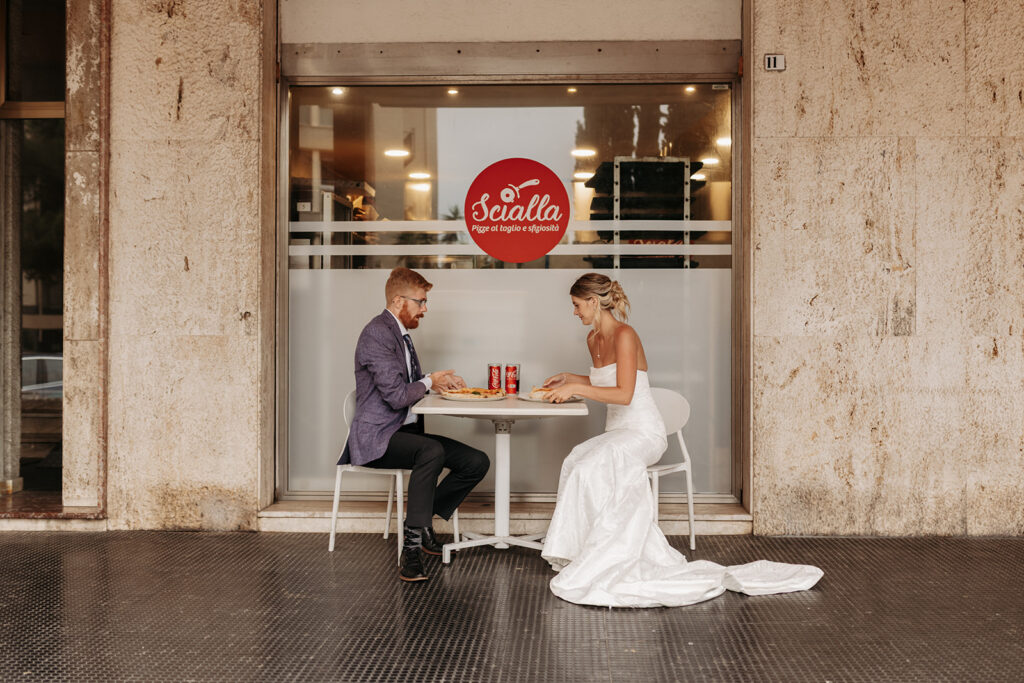 bride and groom enjoying a pizza break in cagliari during their sardinia elopement
