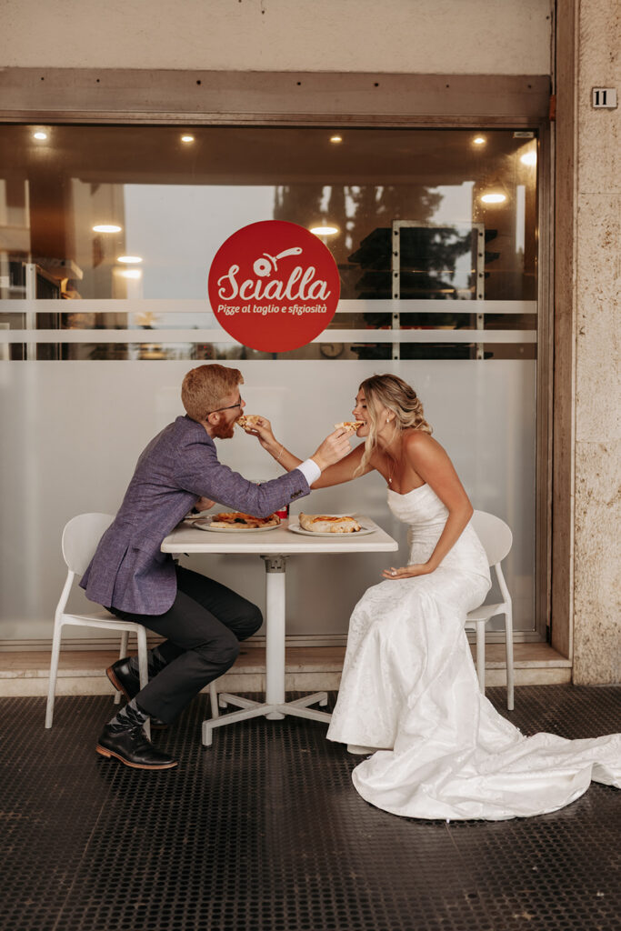 bride and groom enjoying a pizza break in cagliari during their sardinia elopement