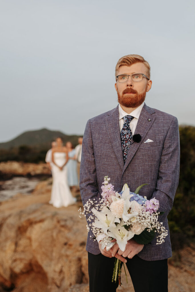 candid bride and groom elopement first look on a cliff in sardinia