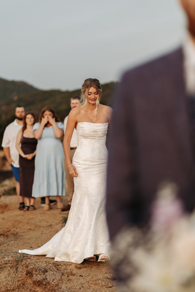 candid bride and groom elopement first look on a cliff in sardinia