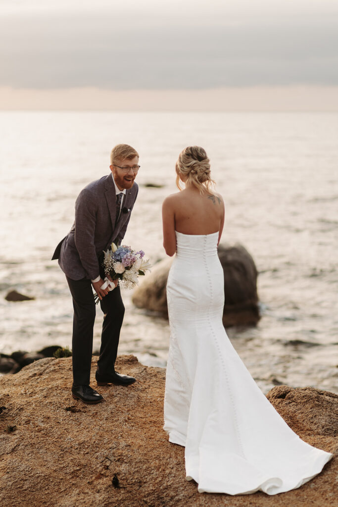 candid bride and groom elopement first look on a cliff in sardinia