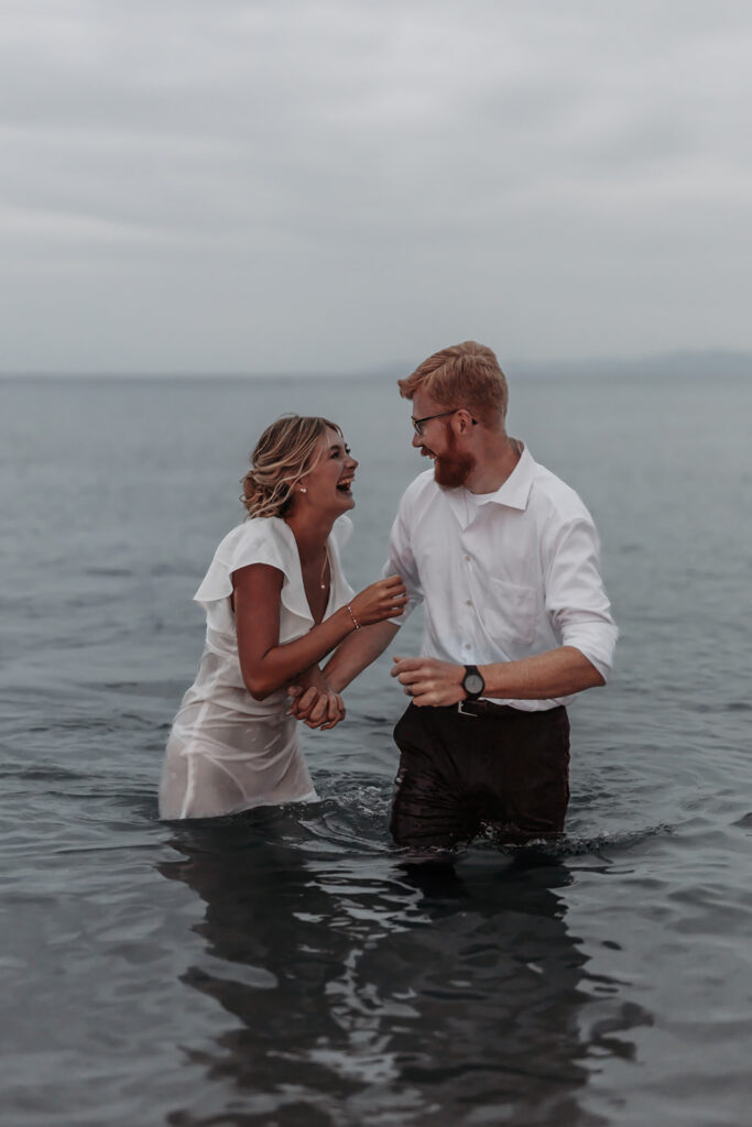 bride and groom being playful in the water during their elopement in sardinia