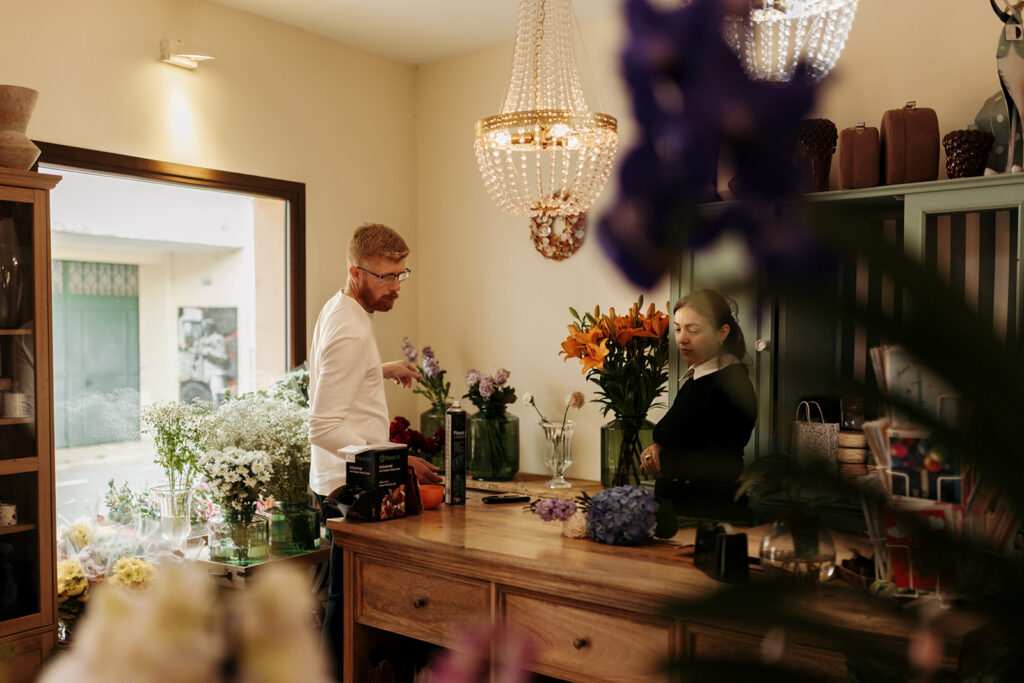 groom picking flowers at a flower shop