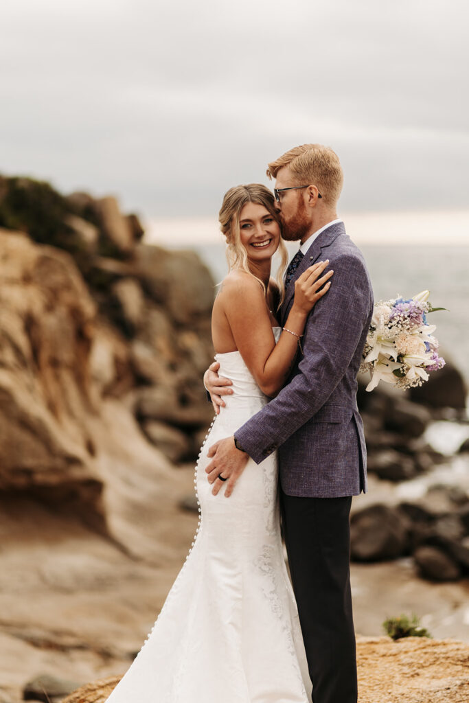 sweet elopement couple on a small cliff during their sardinia elopement