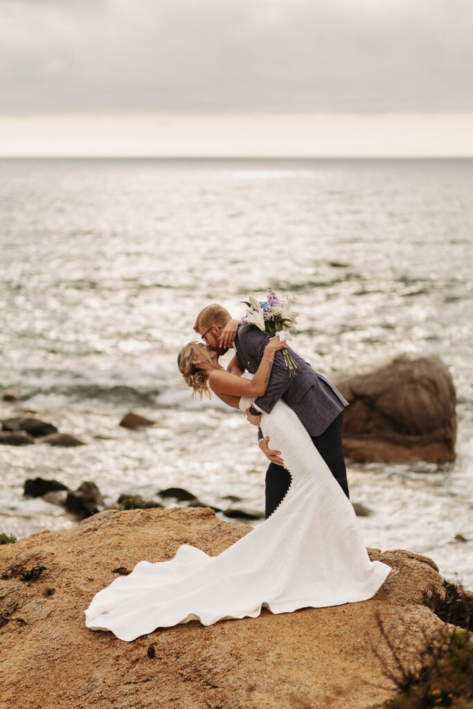 elopement couple dip kiss on a small cliff during their sardinia elopement