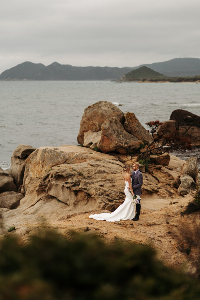 sweet elopement couple on a small cliff during their sardinia elopement